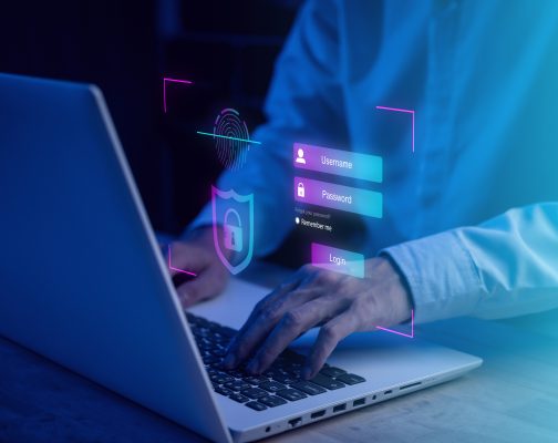 Username and password (Login) with biometric identification fingerprint scanner, encryption for technology cyber security internet and networking system. Businessman hand typing notebook (Laptop).